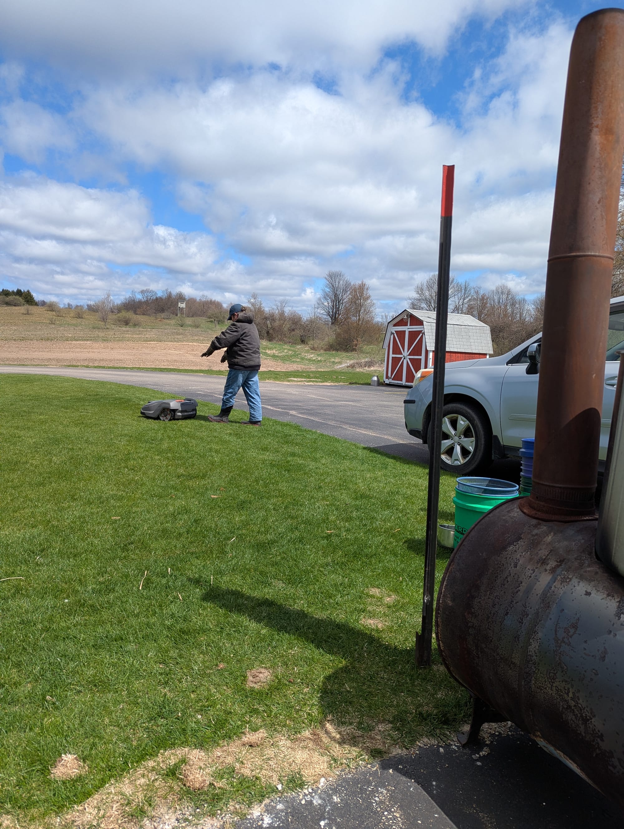 Wiley attempts to shoo the ominous robot lawnmower away from the biochar stove