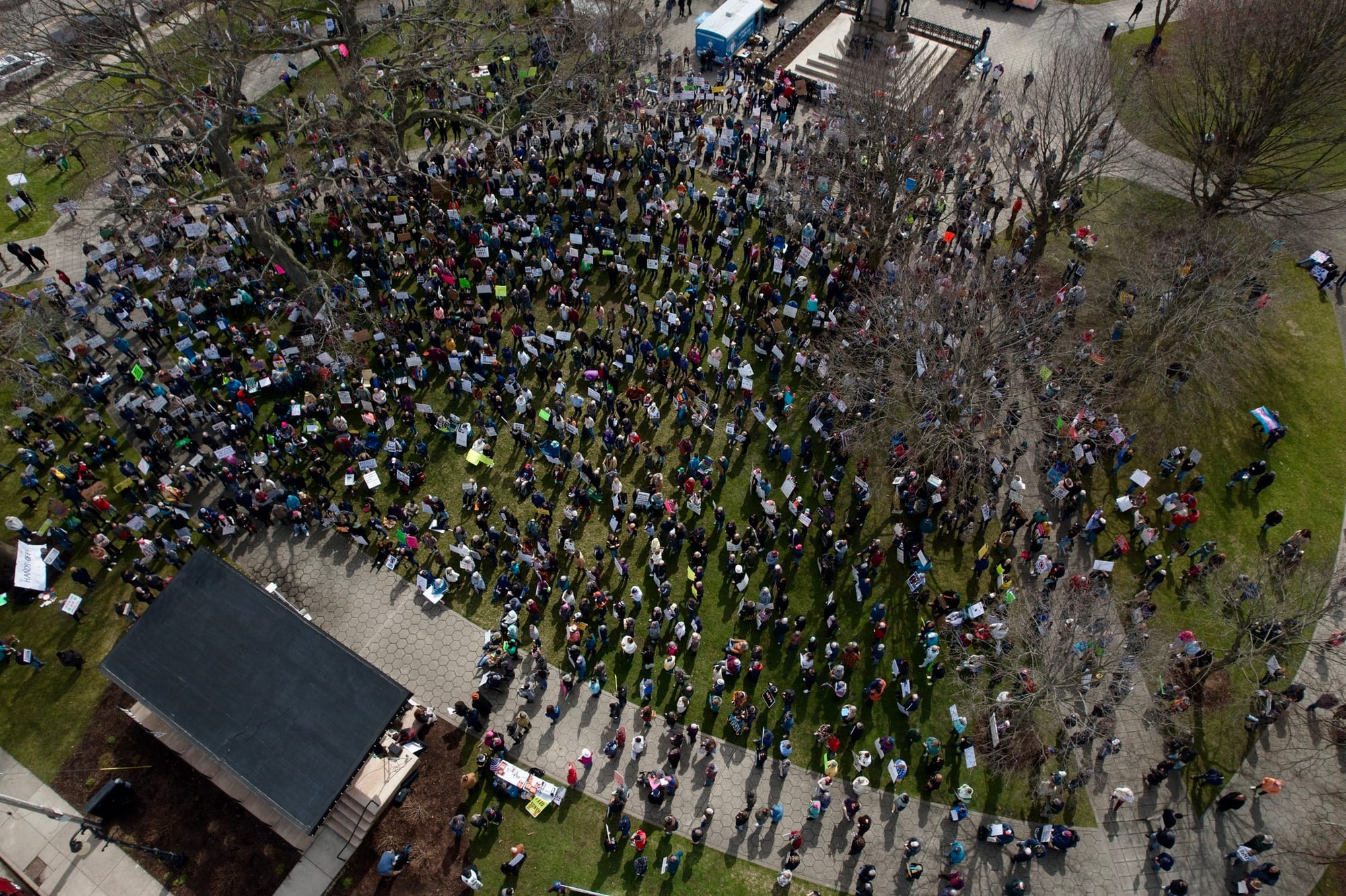 A picture showing the crowd at the Muskegon Hands Off rally on Saturday. It is an aerial view from a drone, and it's hard to count the entire crowd, but it fills quite a large section of Hackley Park.