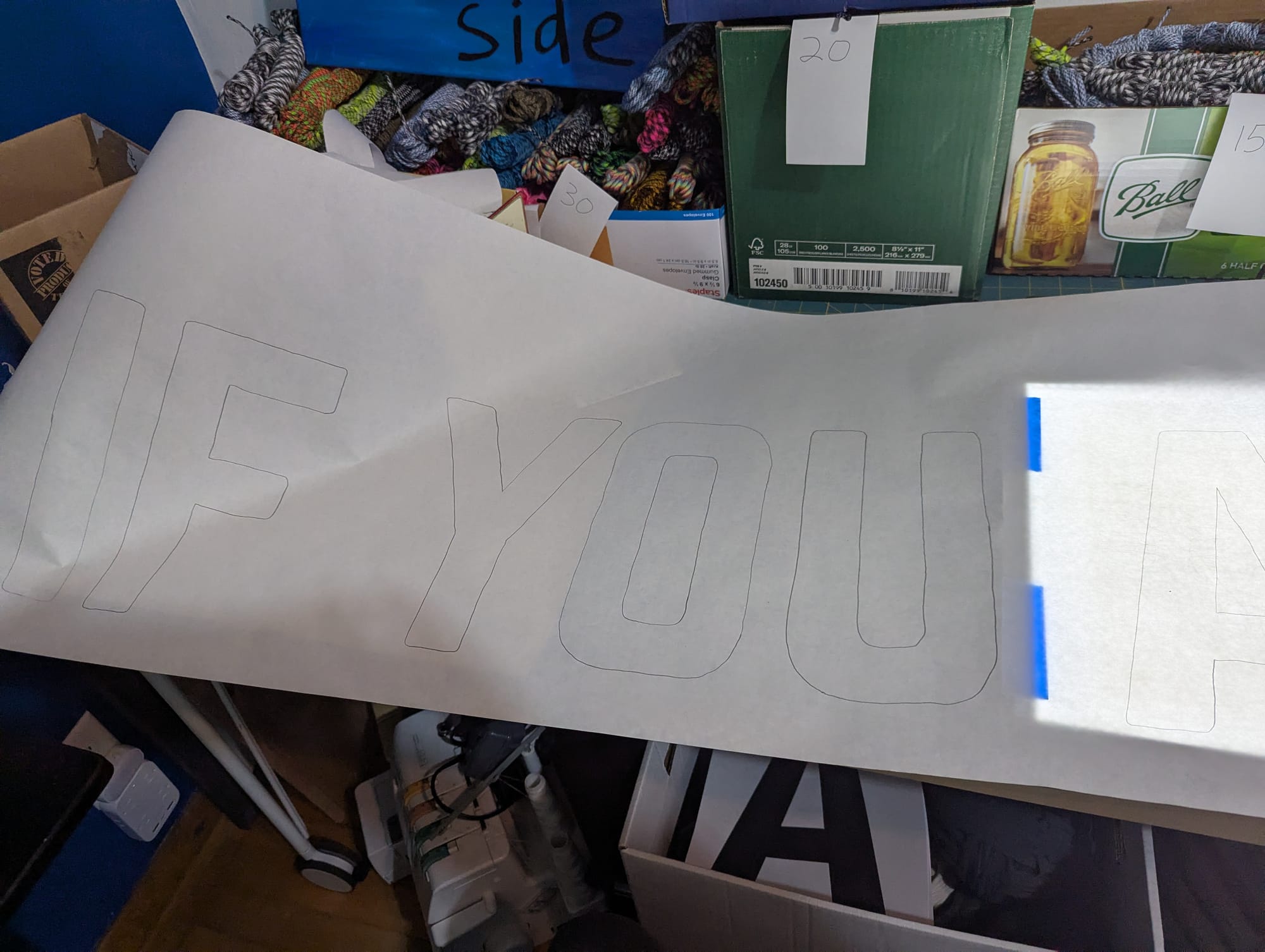 A large piece of freezer paper with the outline of some large letters reading "if you"