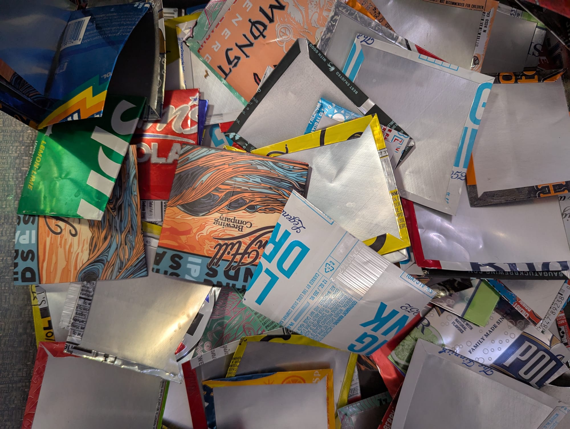 A big pile of plant tags made out of aluminum cans