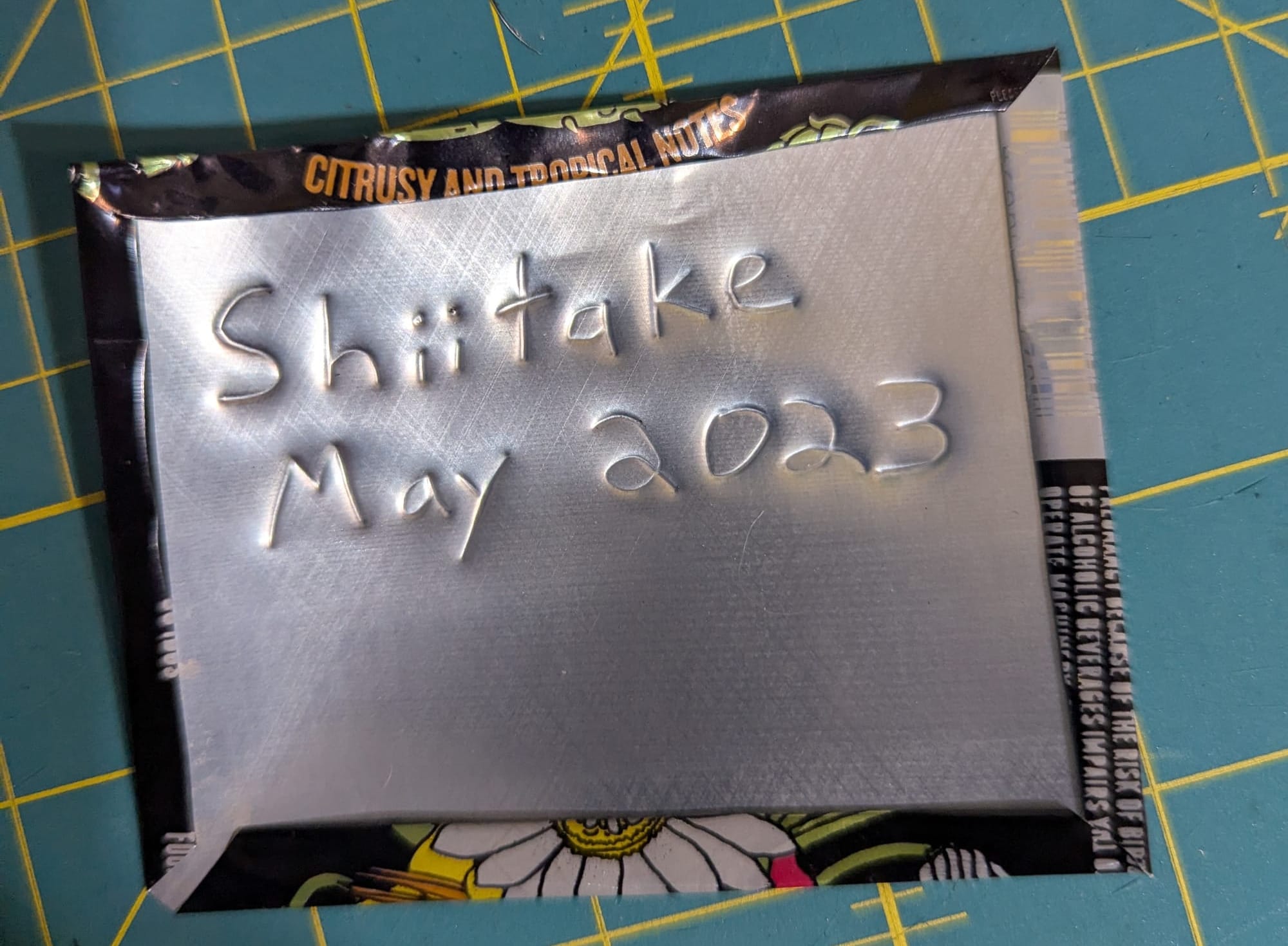 The finished tag, now with handwritten lettering reading "Shiitake, May 2023"