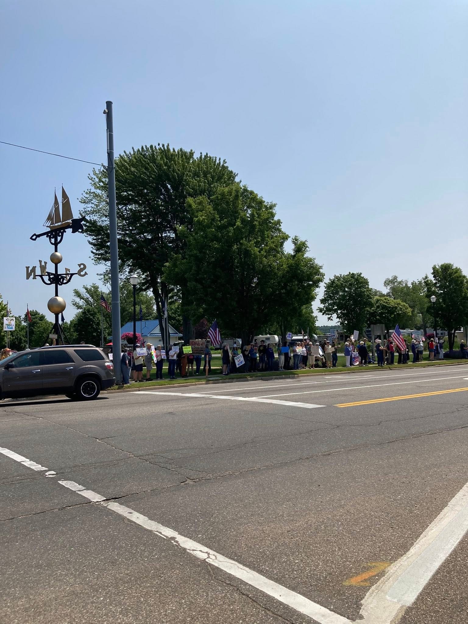 Protesters lined up along the sidewalk in front of the Weathervane.