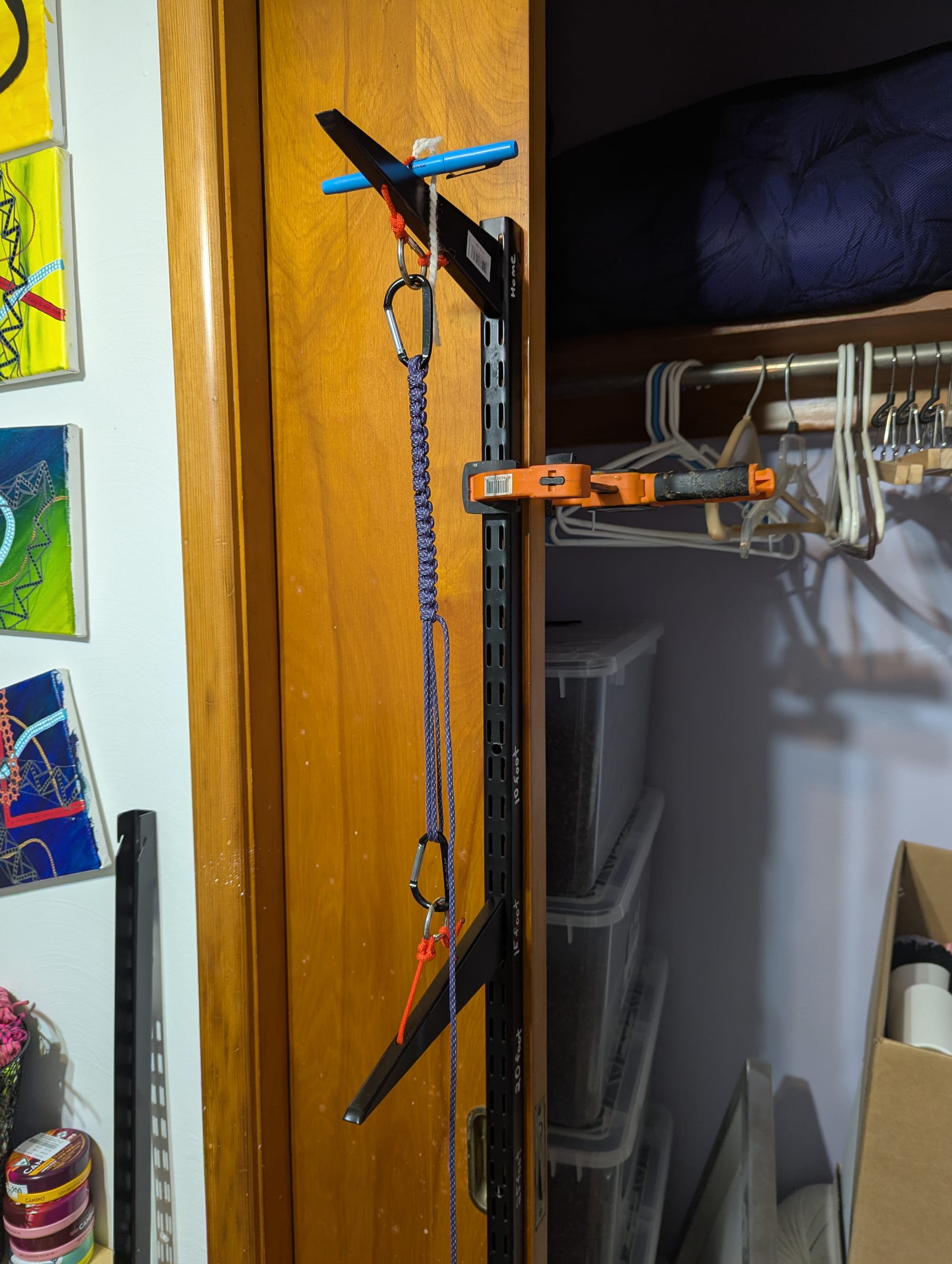 A handle tying rack made out of adjustable shelving parts and clamped to a closet door
