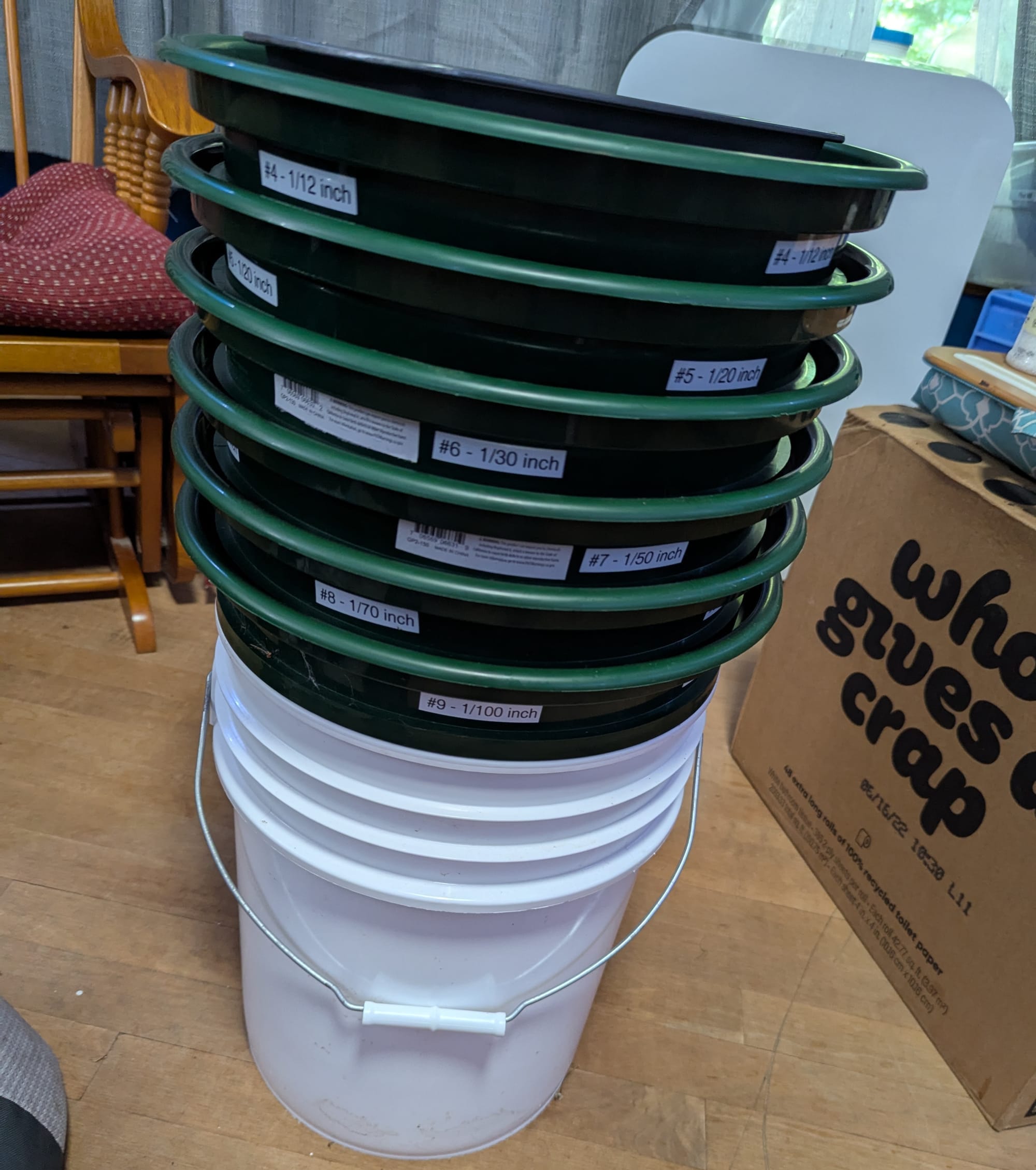 A set of green stacking sifters in sizes ranging from 1/12 inch to 1/100 inch