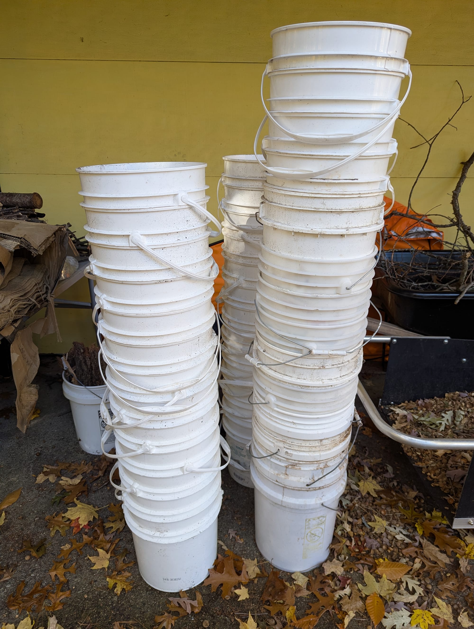 Several large stacks of white buckets looking a little the worse for wear