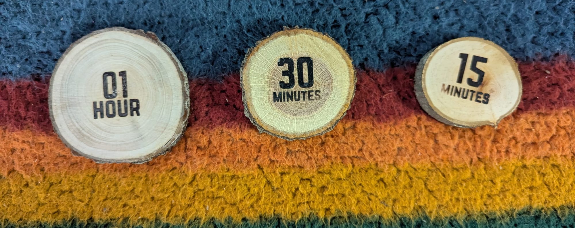 A big token with "01 Hour", a medium token with "30 minutes" and a small token with "15 minutes" burned into them